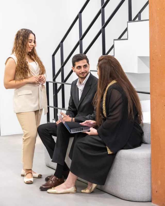 Loopex Digital team members talking together in the office